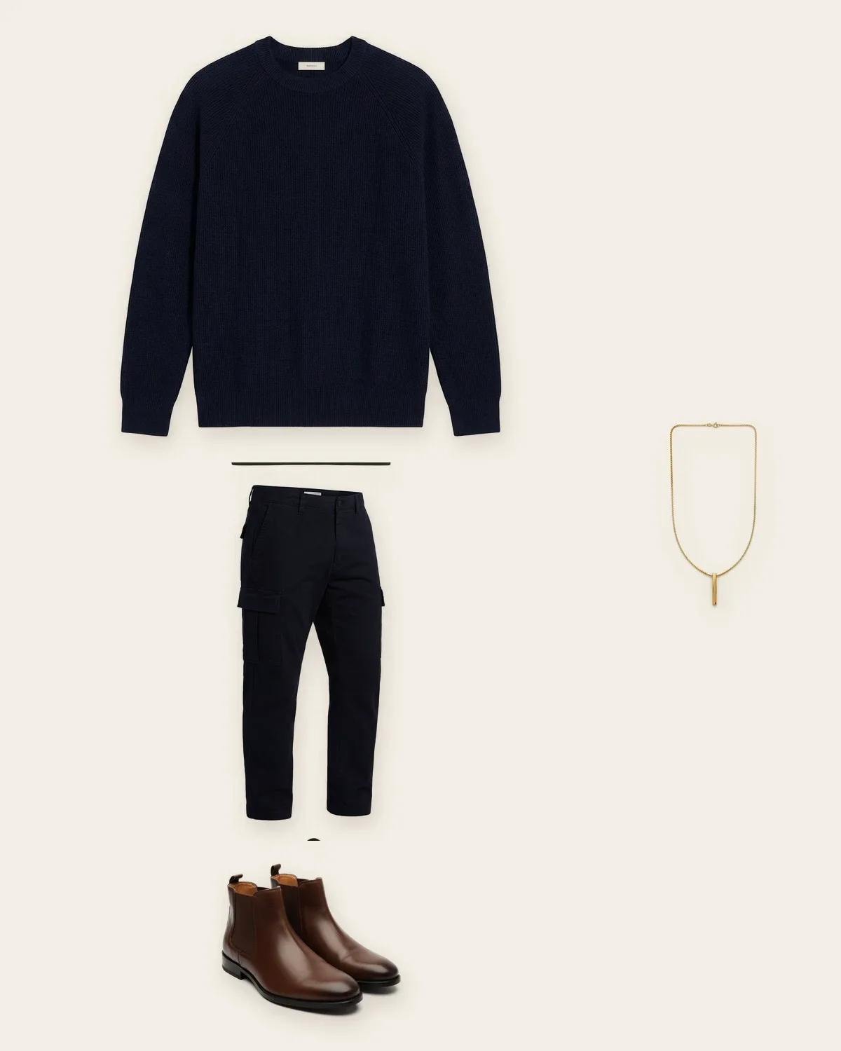 A navy sweater, cargo trousers and boots laid out as one look